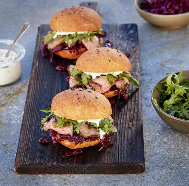 Three Tri-Top Sliders atop a small wood plank used for serving.